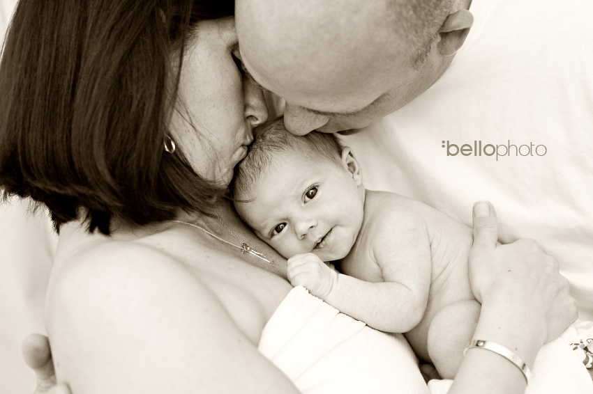 newborn getting kisses