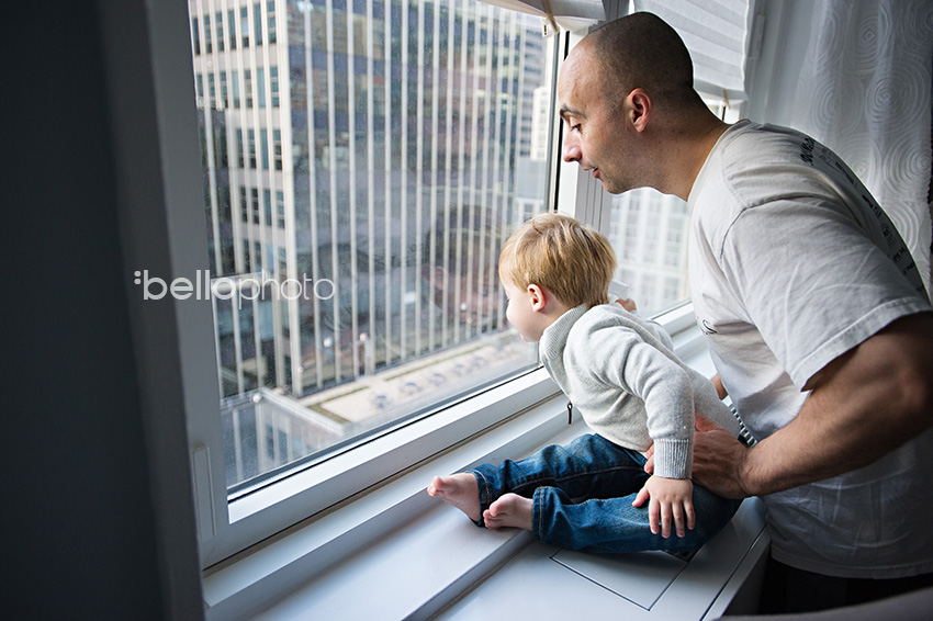 little boy & dad looking out NYC apartment window, NYC life