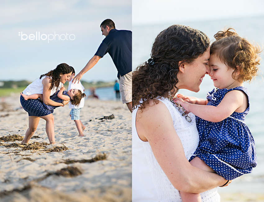 mom playing with baby daughter on beach