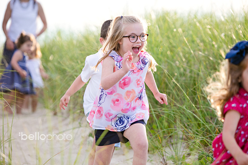 girl running through beach grass