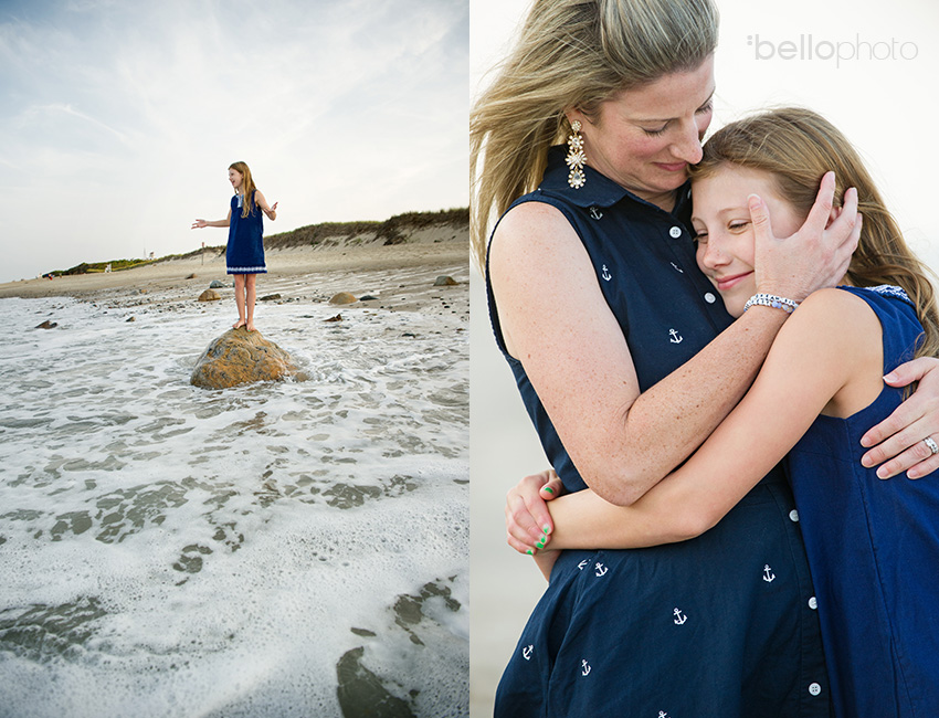 mom hugging daughter at the beach, girl standing on rock at beach