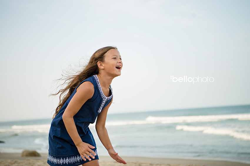 girl running with unbridled joy at the beach