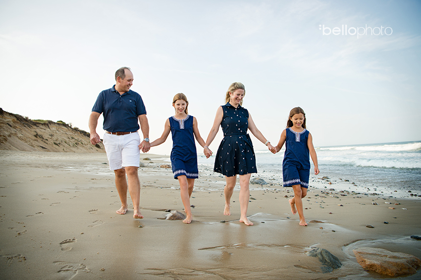 Family walking along the beach holding hands on Cape Cod