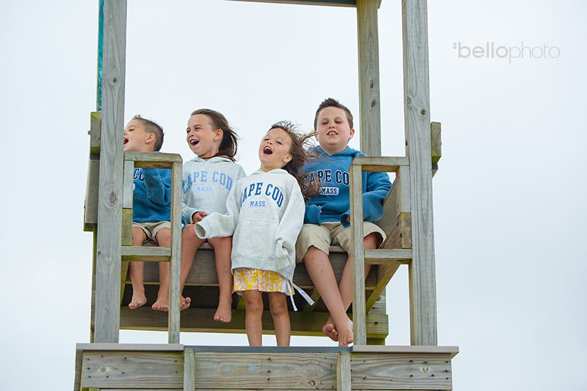 cute kids in tall lifeguard chair at the beach