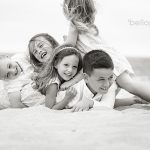 kids pig piling at the beach, black & white photo