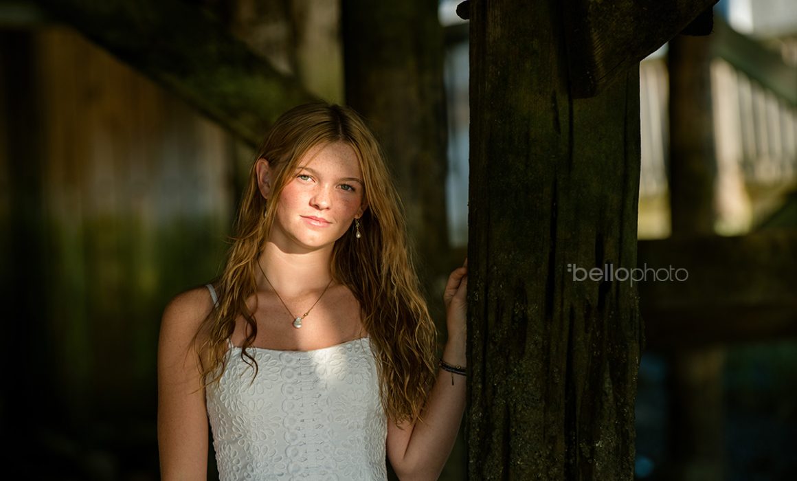 Gorgeous girl in cool light under beach boardwalk